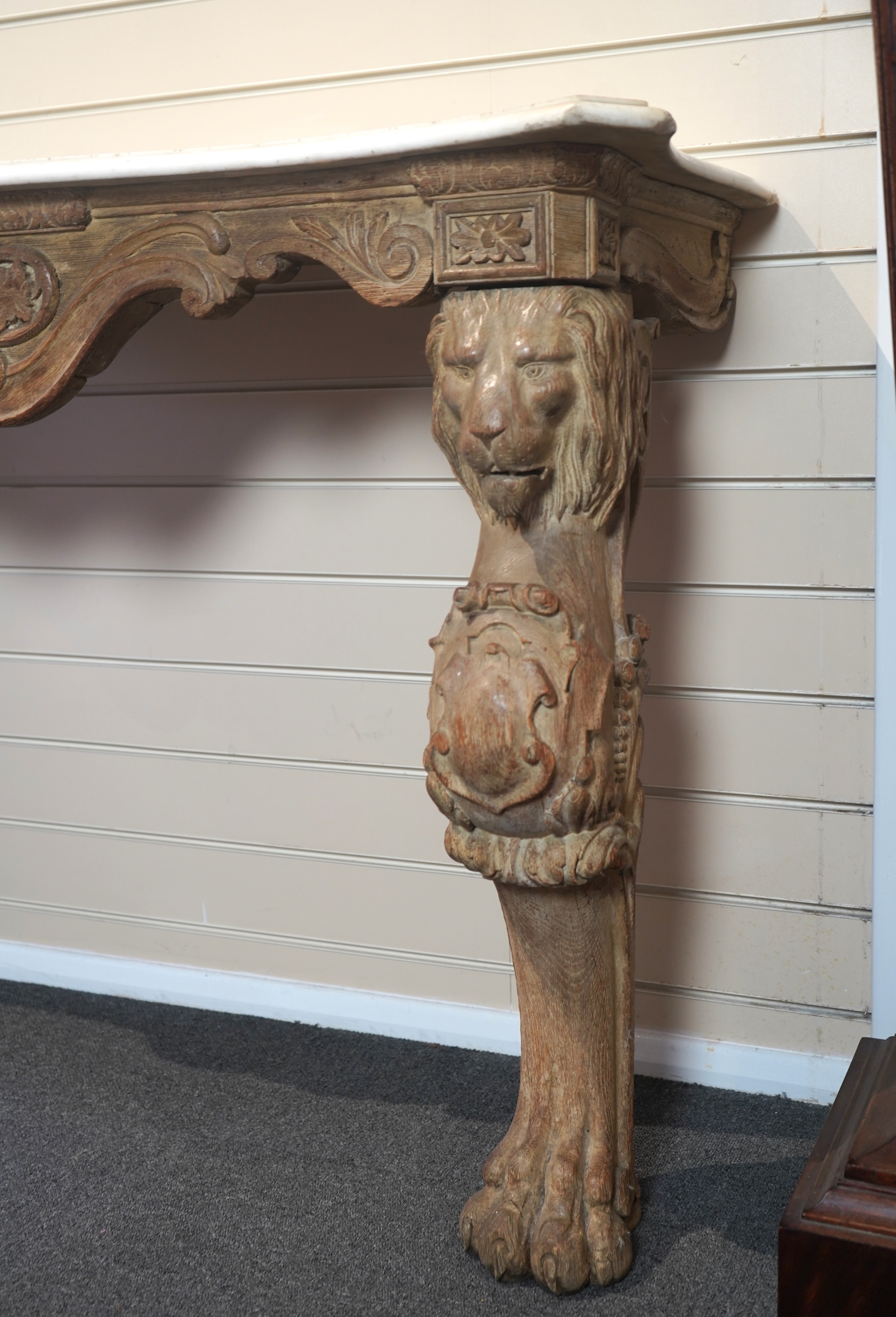 A 19th century Baroque style marble topped limed oak serpentine console table